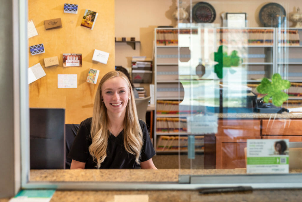 Woman at front desk smiling