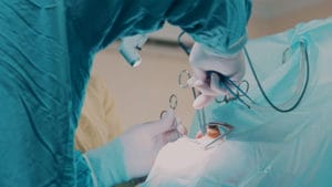 doctor performing oral surgery