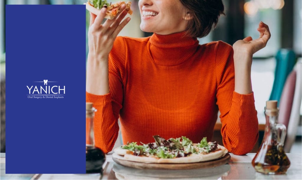 woman eating pizza with orange long sleeve shirt